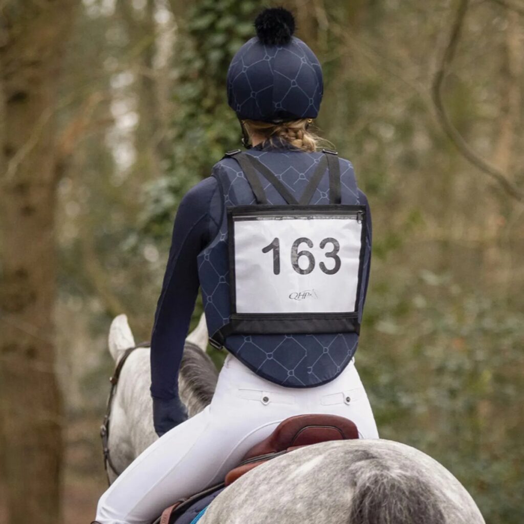 Competition rider wearing a number bib.