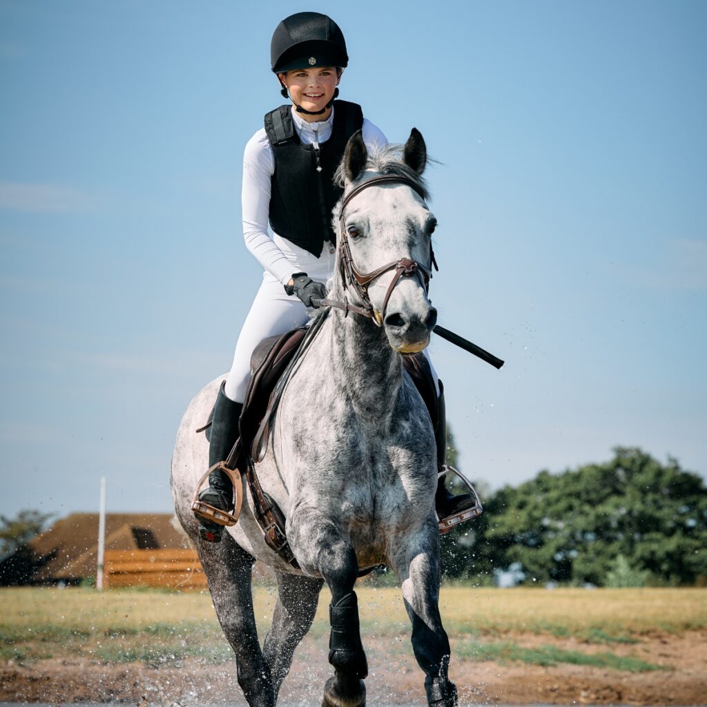 Young rider riding cross country.